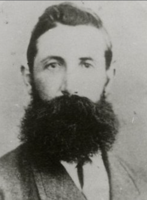 Portrait of Constable Michael Scanlan with dark hair and a thick beard